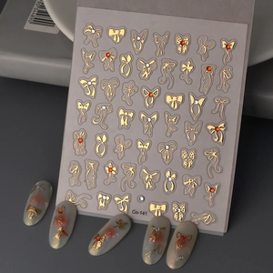 Golden bow nail art stickers set with rhinestones and Co-141 metallic decorative decals