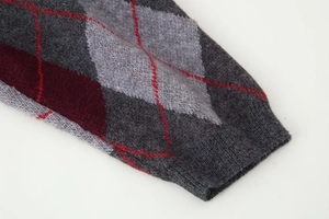 Close-up of the ribbed cuff and argyle pattern on a vintage loose knit sweater
