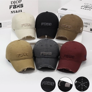 Detail view of vintage distressed baseball caps showing embroidery and worn-out brim texture