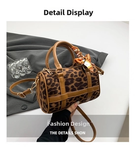 Detailed macro of leopard print Boston bag with silk scarf and gold hardware accessories