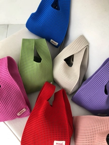 Colorful collection of hollow-out knit tote bags in vibrant solid colors and waffle texture