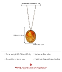 Detail van ovale zinklegering ketting met Jezus Geboorte scène onder glazen koepel