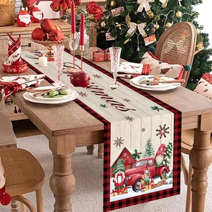 Christmas table runner with gnome red truck and snowflakes on a wooden table setting