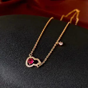 Gold plated heart pendant necklace featuring red zircon and micro-set white stones