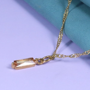 Close-up of champagne rectangle gemstone pendant on gold water wave chain necklace