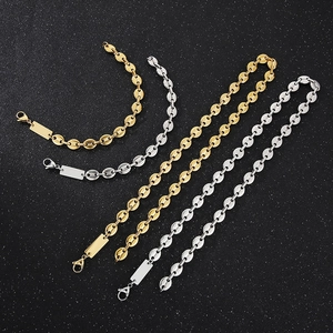 Flat lay of gold and silver titanium steel pig nose chains with blank rectangle tags