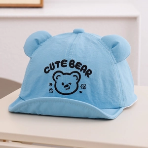 Close-up of cute bear embroidery and 3D ears on a light blue quick-dry baby sun hat