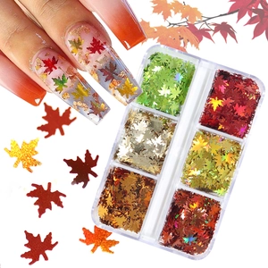 6-grid box of holographic maple leaf nail sequins in autumn colors for festive nail art