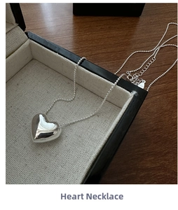 Detailed view of the S925 sterling silver heart pendant with its hallmark and beaded chain