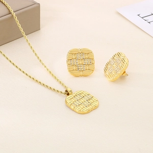Detail of 18K gold plated twisted chain necklace and square rhinestone stud earrings set