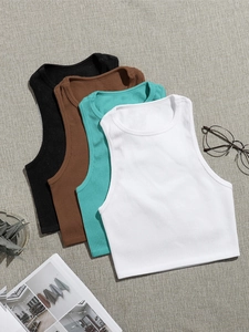 Flat lay of ribbed knit yoga tank tops in black, brown, teal, and white colors