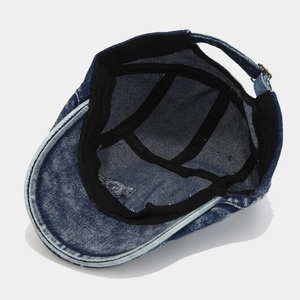 Interior view of vintage washed denim newsboy cap with adjustable metal buckle closure