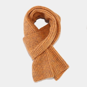 Detailed view of the ginger yellow thick ribbed knit texture on this winter scarf set