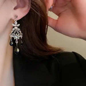 Vintage palace style silver earrings with sparkling crystals and black waterdrop tassels