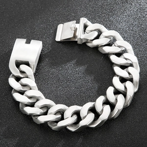 Detailed top view of a wide silver stainless steel cuban chain bracelet on black background