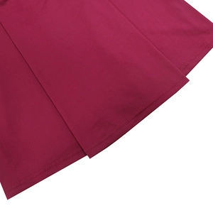 Detailed view of the double-needle stitched hem on a wine red knit sleeveless dress