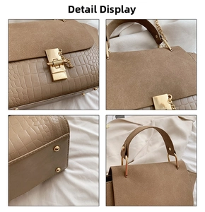 Detail showing the brown crocodile texture PU leather and matte suede flap of the handbag