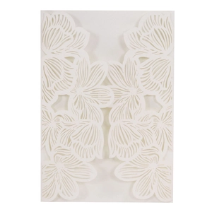 Detail of laser-cut white floral invitation card featuring intricate hollow rose patterns