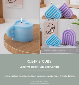Detailed view of light blue heart and purple arched candles in a cozy home setting