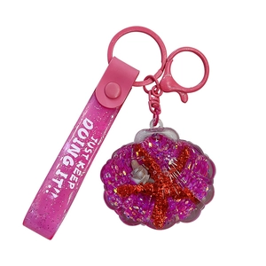 Rosa Muschel-Schlüsselanhänger mit flüssigem Treibsand, Seestern und Glitzerband