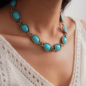 Macro detail of retro resin turquoise oval pendant necklace with vintage gold metal frame