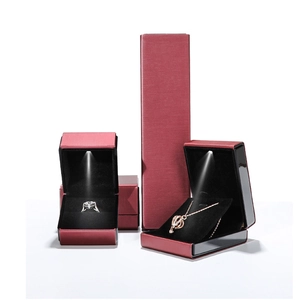 Red jewelry box set with LED light including ring and necklace boxes on white background