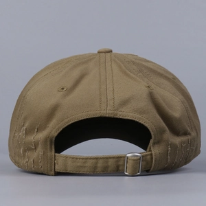 Detail of adjustable metal buckle and distressed ripped brim on cotton baseball cap