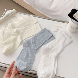 Three-pack of breathable hollow-out cotton crew socks in cream, grey, and white