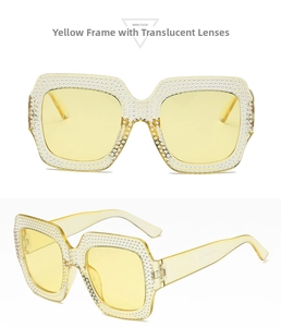 Detailed view of yellow crystal frame sunglasses with shiny rhinestone embellishments