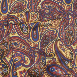 Close-up of paisley print fabric detail with intricate stitching and rich color pattern