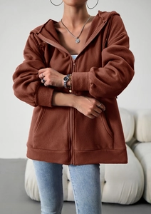 Detailed macro view of the brown fleece hoodie zipper, pocket and fabric texture