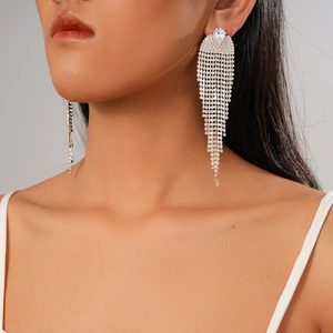 Elegant silver tassel earrings with teardrop zircons worn by a model on a grey background