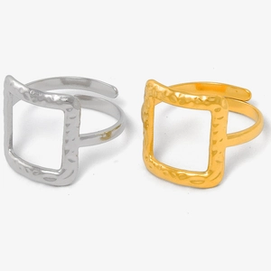 Detailed macro view of square rings with hammered texture in gold and silver finish