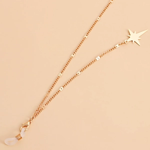 Detailed close-up of golden glasses chain with star pendant and lobster clasp