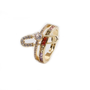 Detailed close-up of gold-plated safety pin ring with colorful cubic zirconia stones