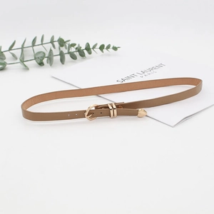 Detail of light brown thin leather hat belt with gold heart-shaped buckle and metal tip