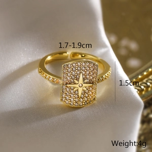 Detailed view of gold plated adjustable ring with rectangle zircon inlay and star pattern