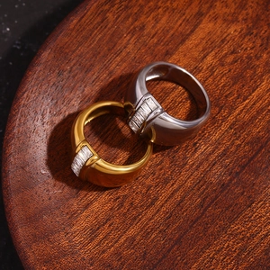Macro shot of 18K gold and silver chunky stainless steel rings with square cubic zirconia