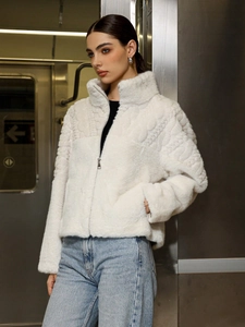 Detailed view of white faux fur jacket with diamond weave texture and stand collar