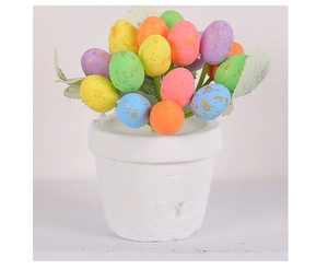 Detailed close-up of colorful speckled Easter eggs and artificial greenery in a pot