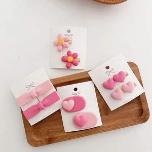 Close-up of pink sweet heart and bow hair clips on a decorative display card