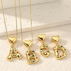 Gold letter pendant necklaces with colorful zircon stones and heart-shaped clasps