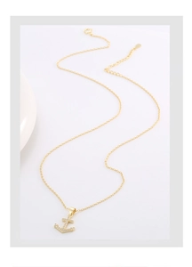 Detailed close-up of golden S925 silver anchor necklace with shimmering pavé micro-zircons