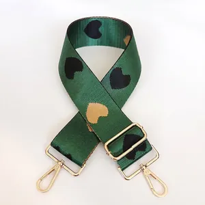 Adjustable wide nylon shoulder strap with green webbing and gold heart jacquard pattern