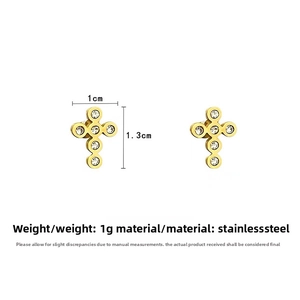 Detail shot of vintage gold-plated stainless steel cross earrings with zircon stones