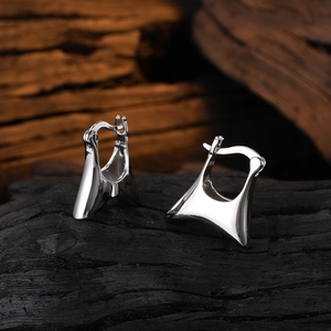 Detailed close-up of S925 hallmark on polished minimalist geometric silver hoop earrings