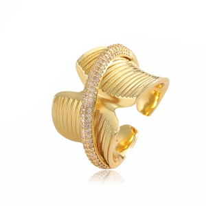 Gold plated wavy open ring with cubic zirconia accents on a minimalist polished band