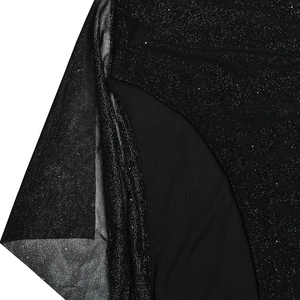Detailed macro view of black chiffon fabric with sparkling silver glitter texture