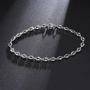 Detail of 4.5mm silver coffee bean link bracelet with a secure lobster clasp on black background