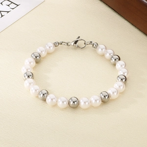 Detail of beaded bracelet showing white pearls and polished silver metal beads with clasp